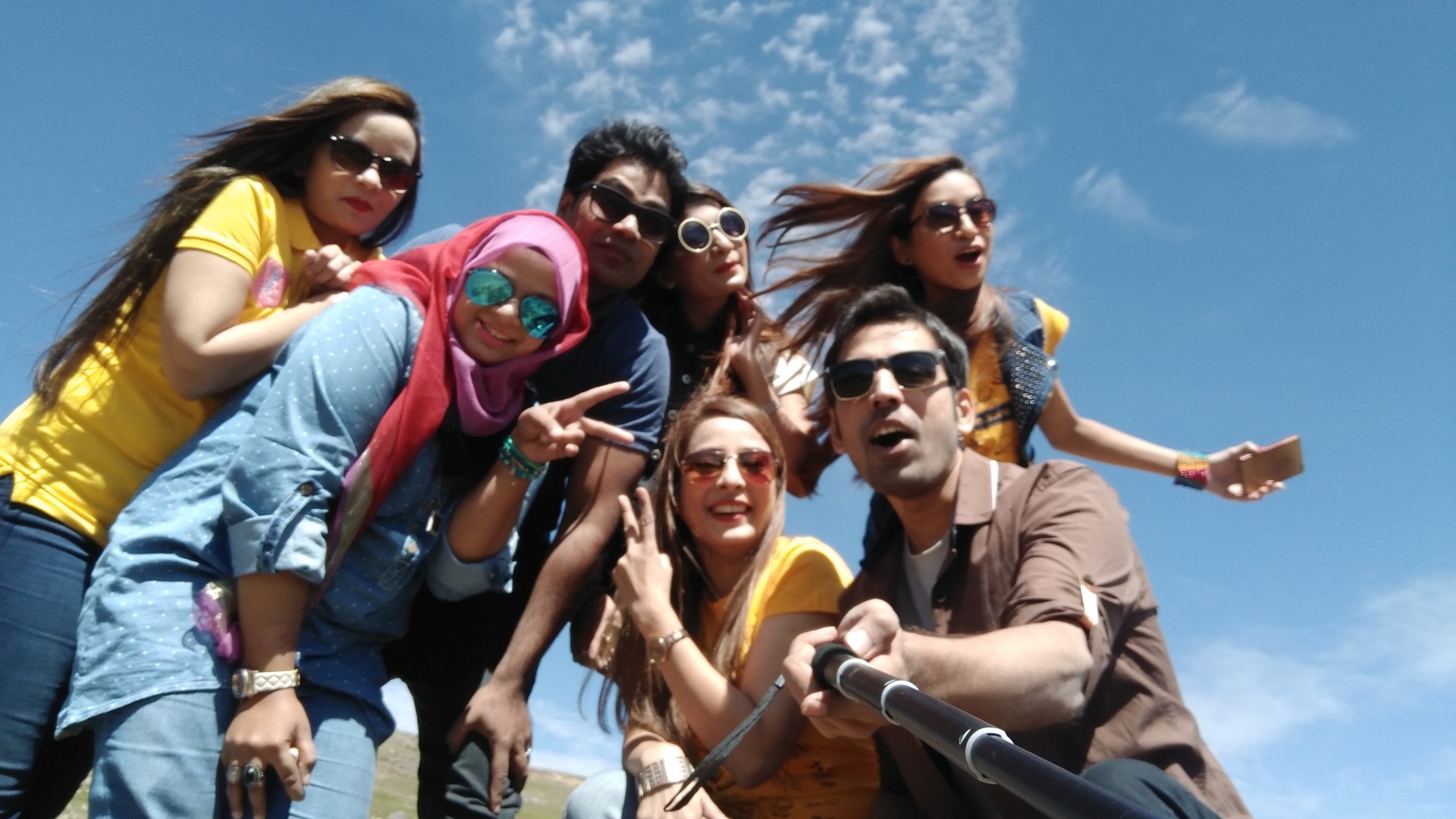 Friends enjoying a sunny day outdoors in Deosai National Park